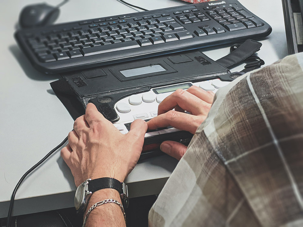 Visually-impaired person using braille keyboard